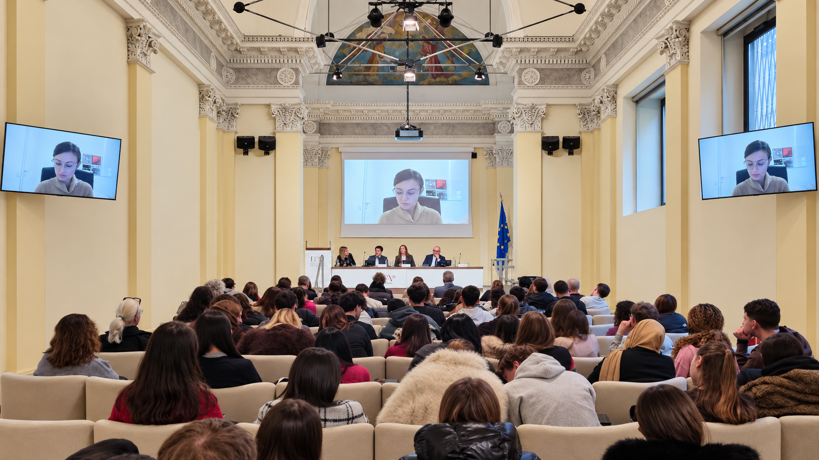Conference in a historic hall with screens